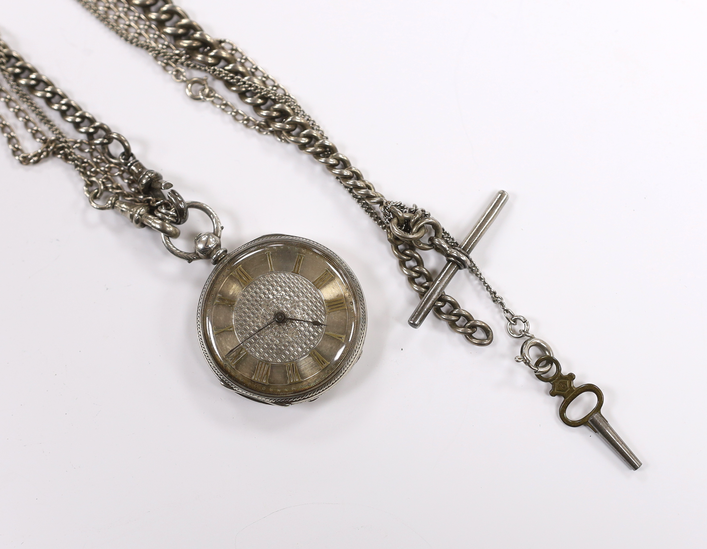 A white metal open face key wind fob watch on a silver albert.